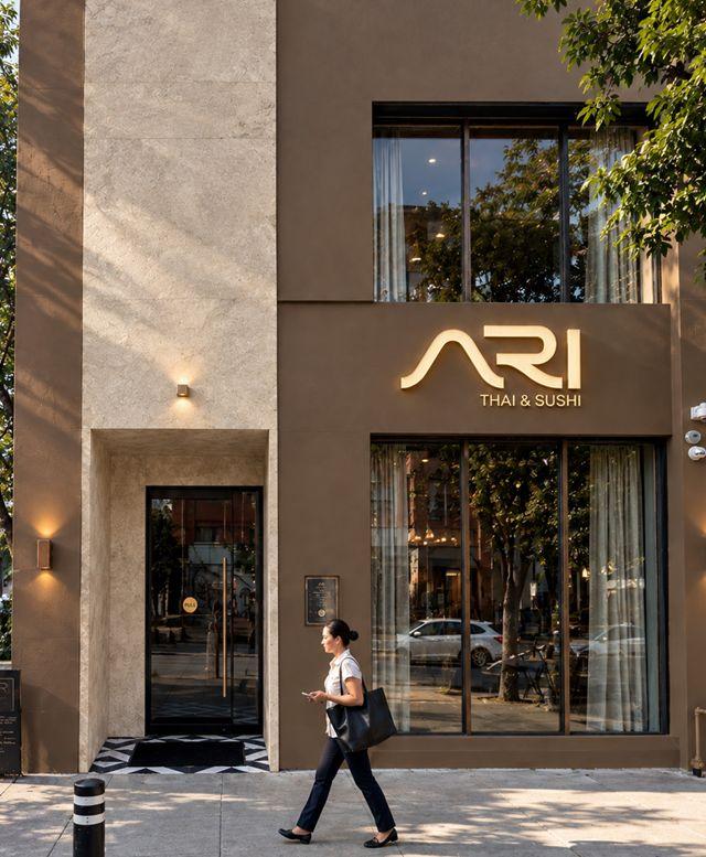 The ARI storefront on St Clair Avenue West, its sign lit at dusk